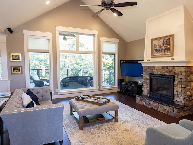 living room featuring a wealth of natural light, dark wood-type flooring, vaulted ceiling, and ceiling fan