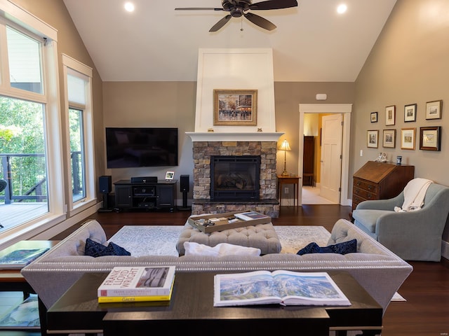 living room featuring ceiling fan, high vaulted ceiling, dark hardwood / wood-style flooring, and a fireplace