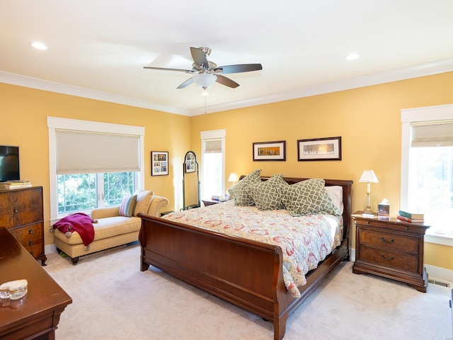 bedroom featuring light carpet, crown molding, and ceiling fan