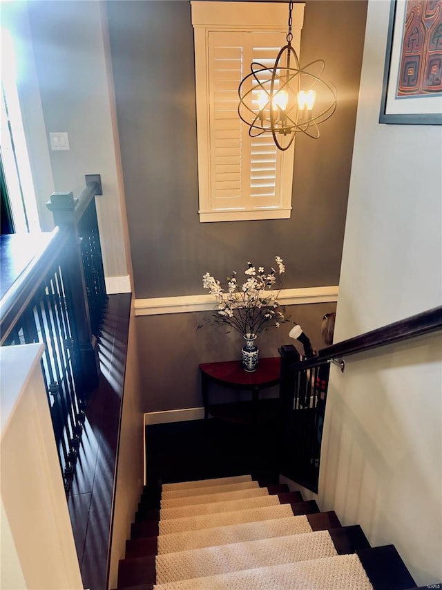 stairs with a chandelier