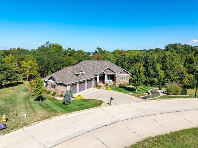 view of front of home with a front yard and a garage