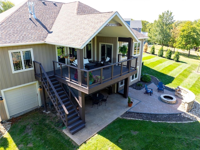 rear view of property with a wooden deck, a patio area, an outdoor living space with a fire pit, and a lawn