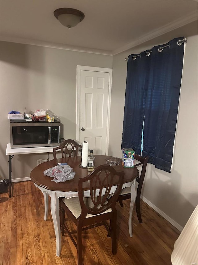 dining room featuring ornamental molding and hardwood / wood-style flooring