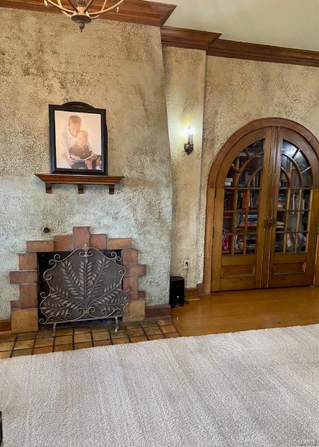 unfurnished living room featuring hardwood / wood-style flooring and ornamental molding