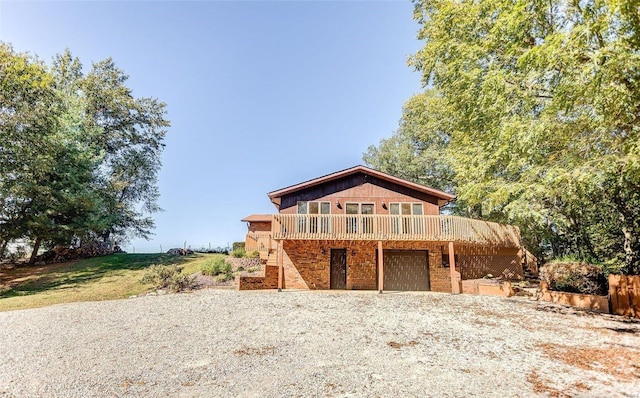 view of front of property with a deck and a garage