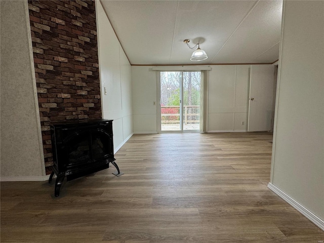 unfurnished living room featuring light hardwood / wood-style floors and a textured ceiling