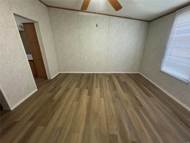 unfurnished room featuring dark hardwood / wood-style floors, ceiling fan, and ornamental molding