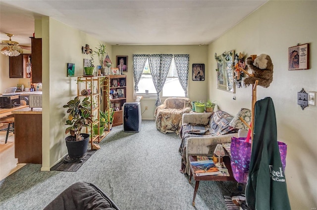 carpeted living room with ceiling fan