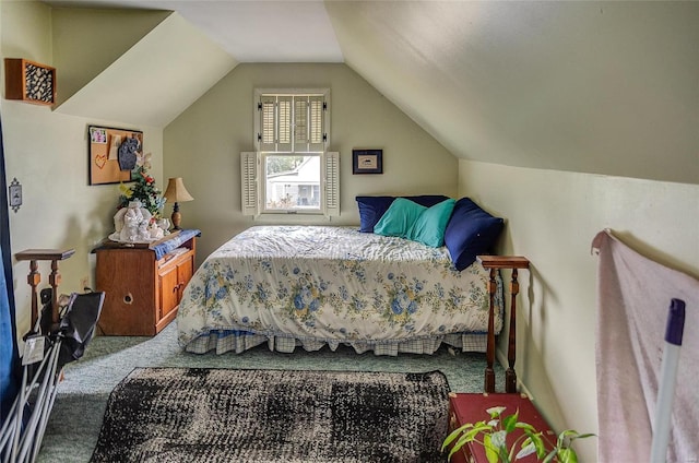 bedroom with vaulted ceiling and carpet