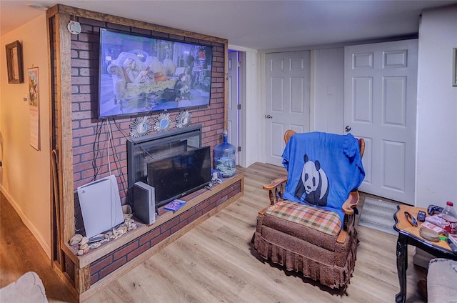 sitting room with wood-type flooring and a fireplace