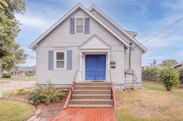 bungalow-style home featuring a front yard