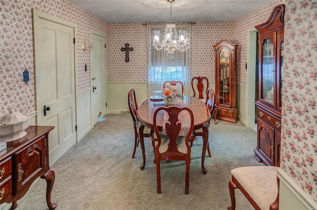 carpeted dining area with a notable chandelier