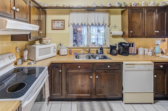 kitchen with white appliances, light tile patterned floors, ventilation hood, dark brown cabinets, and sink