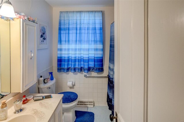 bathroom featuring tile walls, tile patterned flooring, vanity, and toilet