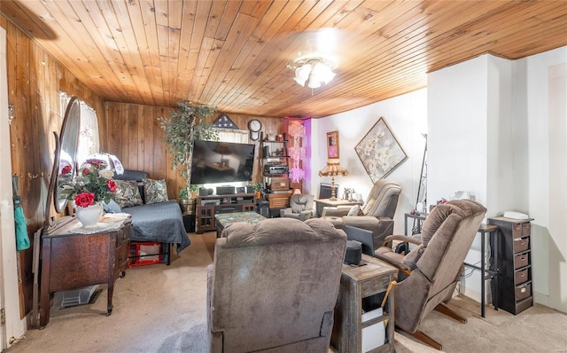 carpeted living room with wood ceiling and wooden walls