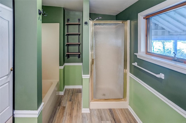 bathroom with wood-type flooring, lofted ceiling, and plus walk in shower