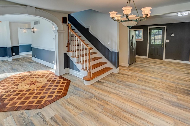 entryway with a notable chandelier and light hardwood / wood-style flooring