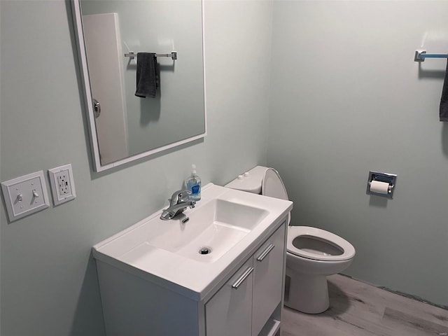 bathroom with vanity, hardwood / wood-style floors, and toilet