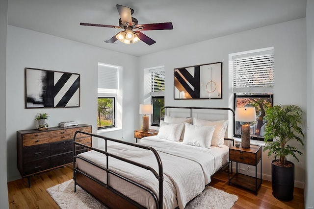 bedroom with hardwood / wood-style flooring and ceiling fan