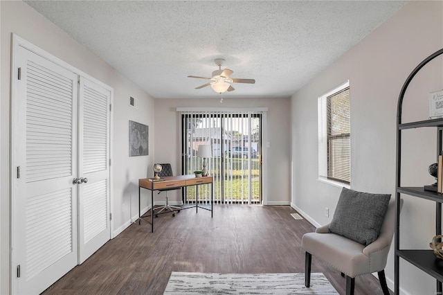 office area with dark hardwood / wood-style floors, a textured ceiling, and ceiling fan