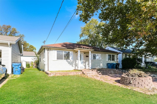 view of front of home with a patio and a front yard