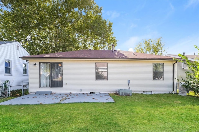 back of house with a yard, cooling unit, and a patio