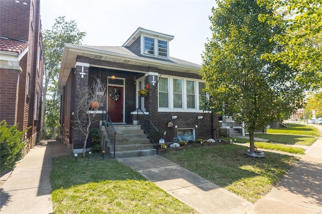 bungalow-style house featuring a front yard