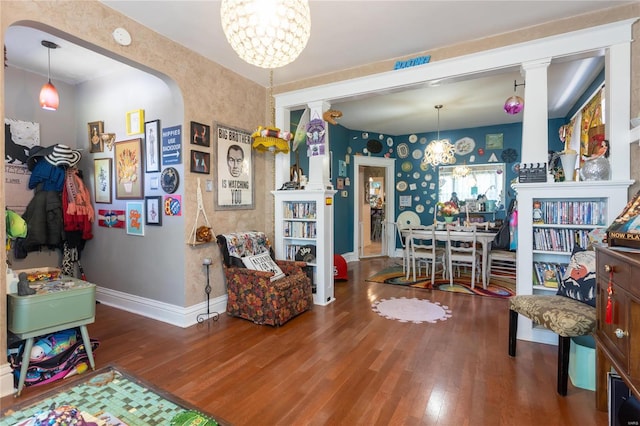 living room with wood-type flooring and a chandelier