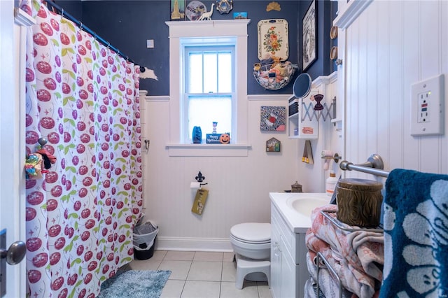 bathroom with walk in shower, vanity, tile patterned flooring, and toilet