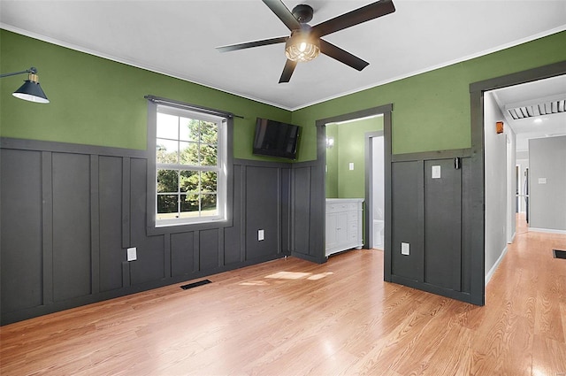 unfurnished bedroom with ornamental molding, light hardwood / wood-style floors, and ceiling fan