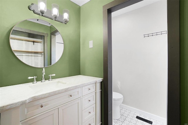 bathroom featuring vanity and toilet