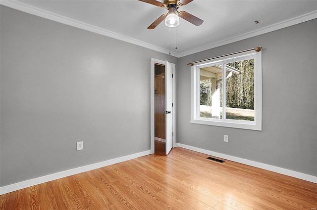 spare room with light hardwood / wood-style floors, ceiling fan, and crown molding