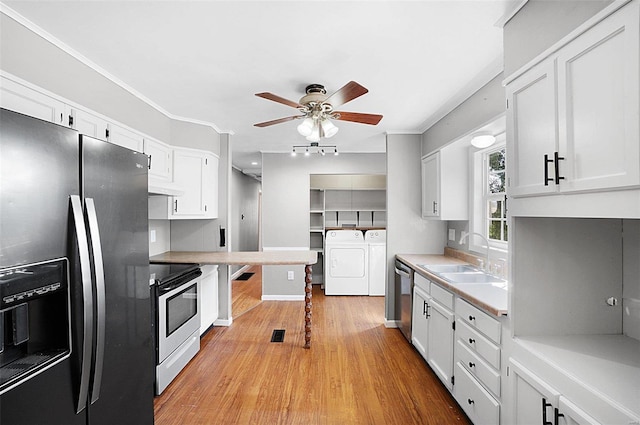 kitchen featuring ceiling fan, white cabinets, stainless steel appliances, and sink