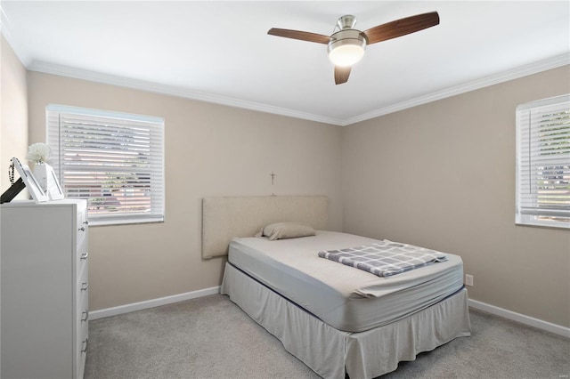 carpeted bedroom with ceiling fan and crown molding