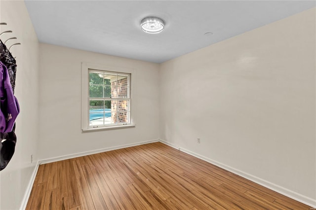 empty room with hardwood / wood-style flooring