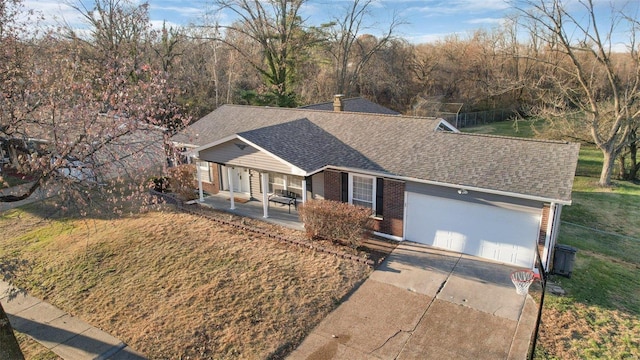 view of front of home with a front yard, a garage, and covered porch