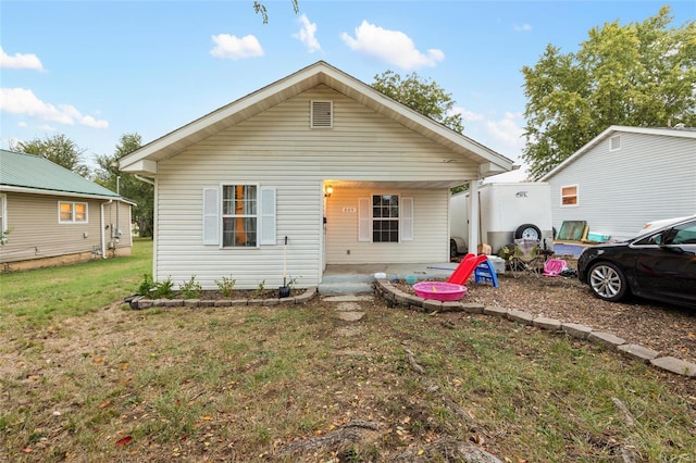 bungalow-style home featuring a front yard