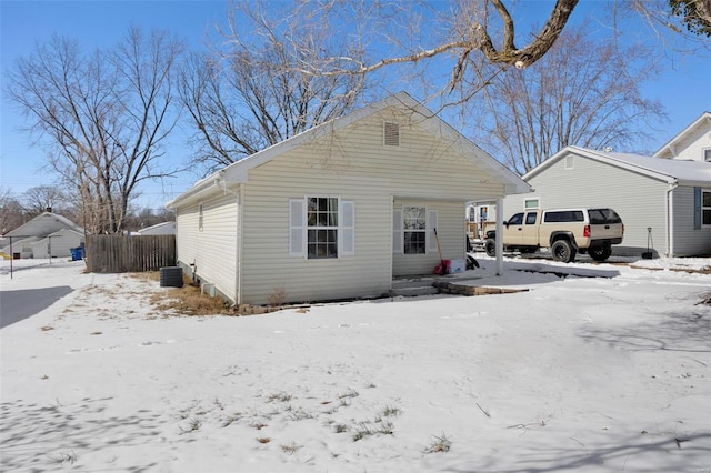 view of front of property with a garage and central air condition unit