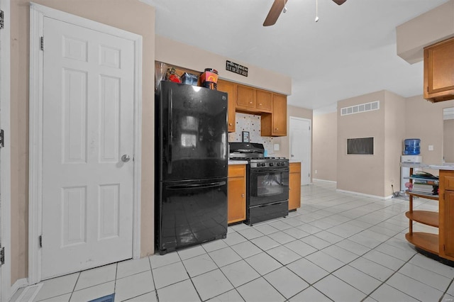 kitchen featuring ceiling fan, light tile patterned flooring, and black appliances