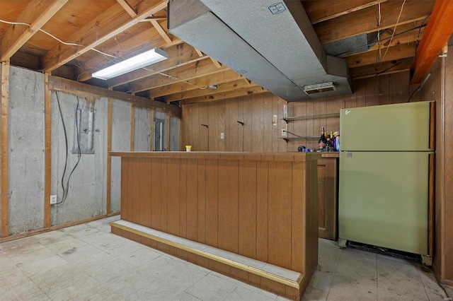 basement with stainless steel refrigerator