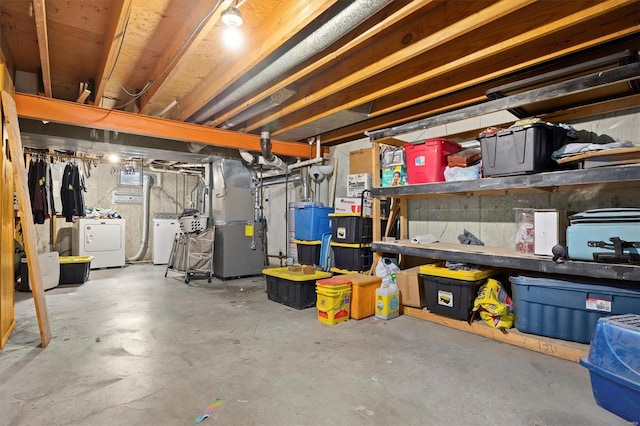 basement with heating unit and washer and dryer