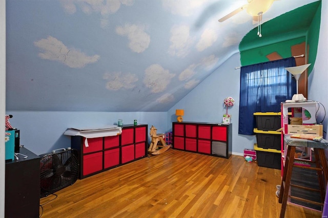 playroom featuring wood-type flooring, lofted ceiling, and ceiling fan