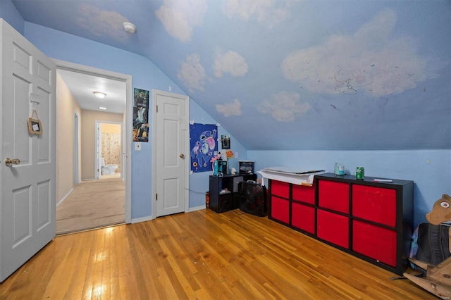 bonus room featuring wood-type flooring and lofted ceiling