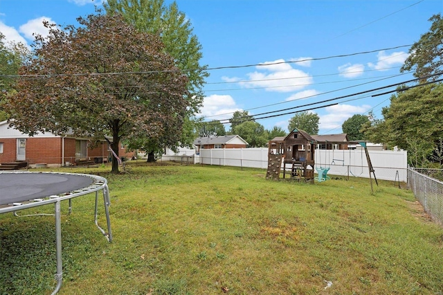 view of yard with a trampoline and a playground