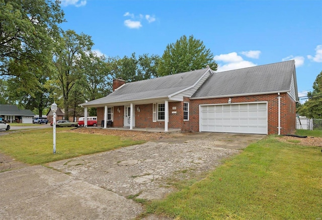 view of front of house with a garage, covered porch, and a front yard