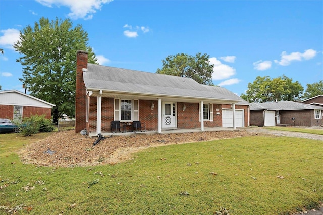 view of front of house featuring a front yard, a garage, and covered porch