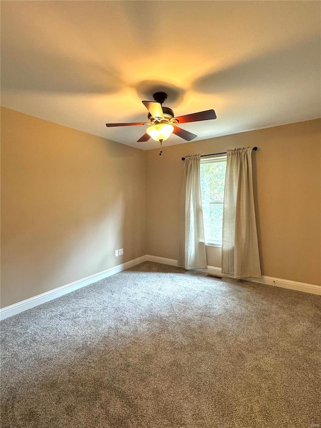 spare room with ceiling fan and carpet flooring