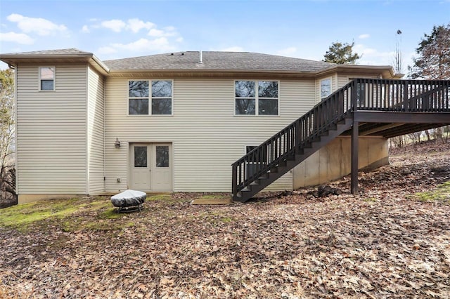 back of property with stairs and a deck