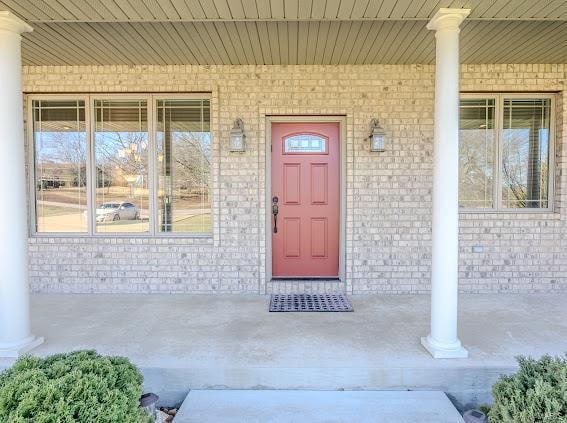 view of exterior entry featuring a porch