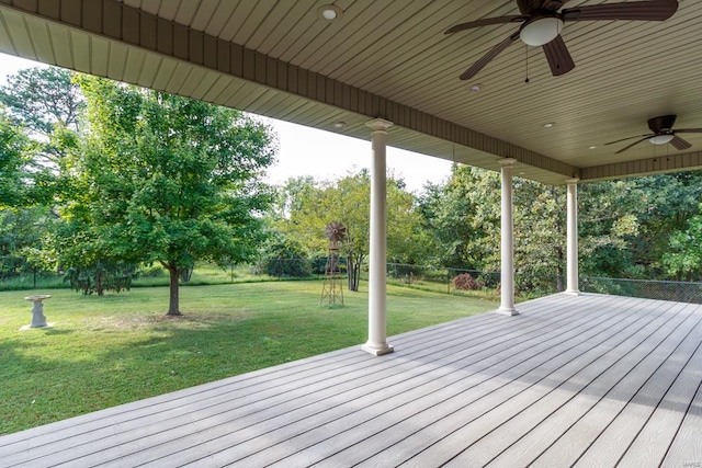 deck with a yard and ceiling fan